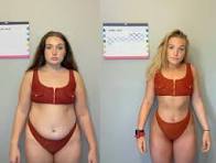 Two young women stand side by side in red bikinis in a plain room with calendars on the wall behind them